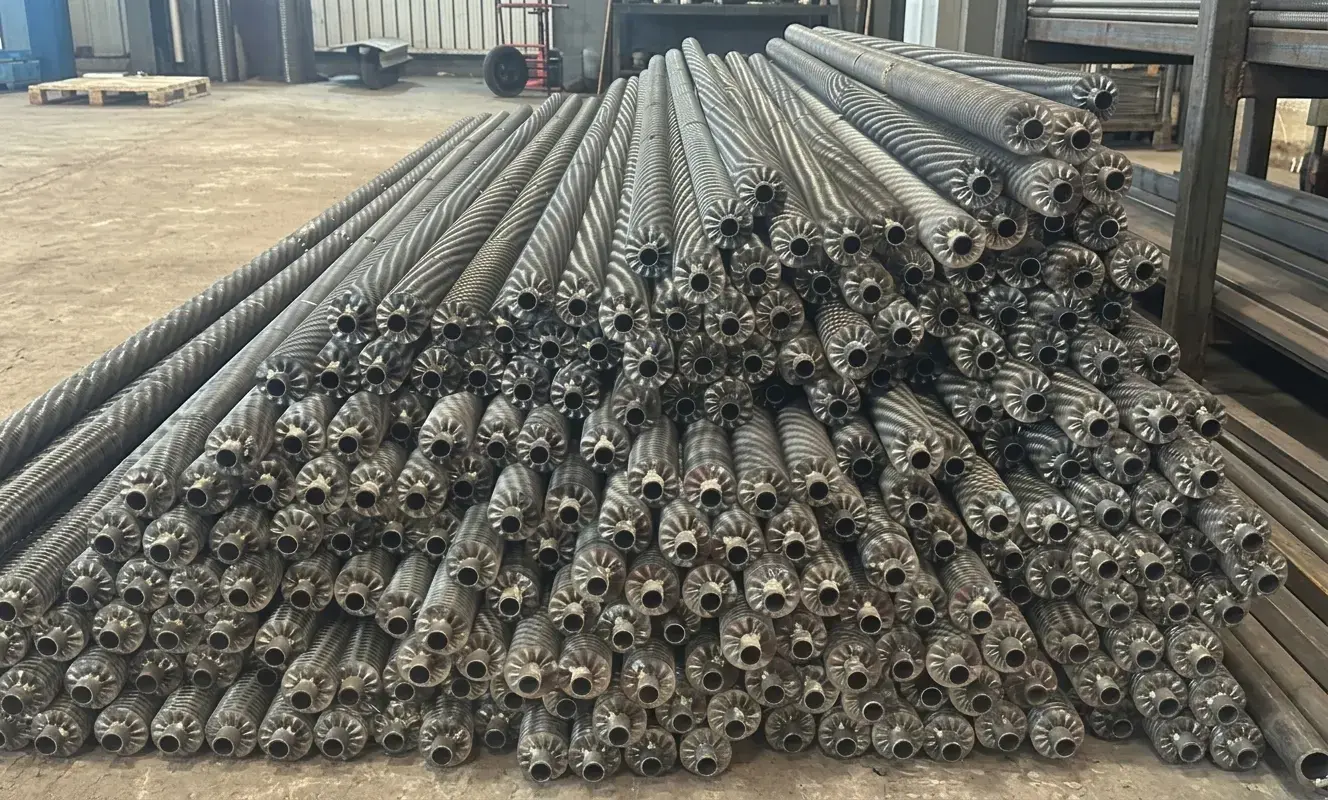 High density monolithic integral low finned tubes rolled directly from base tube wall for compact shell and tube heat exchangers